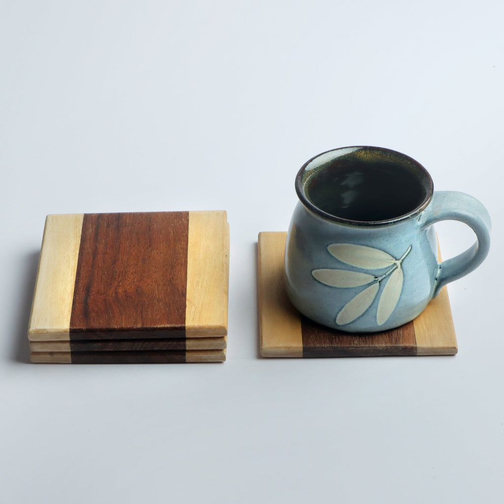 Set of four handcrafted wooden coasters in a square design, made from solid wood. Perfect for protecting surfaces from cups, glasses, and candles. A rustic and elegant addition to any home décor or as a thoughtful gift for special occasions
