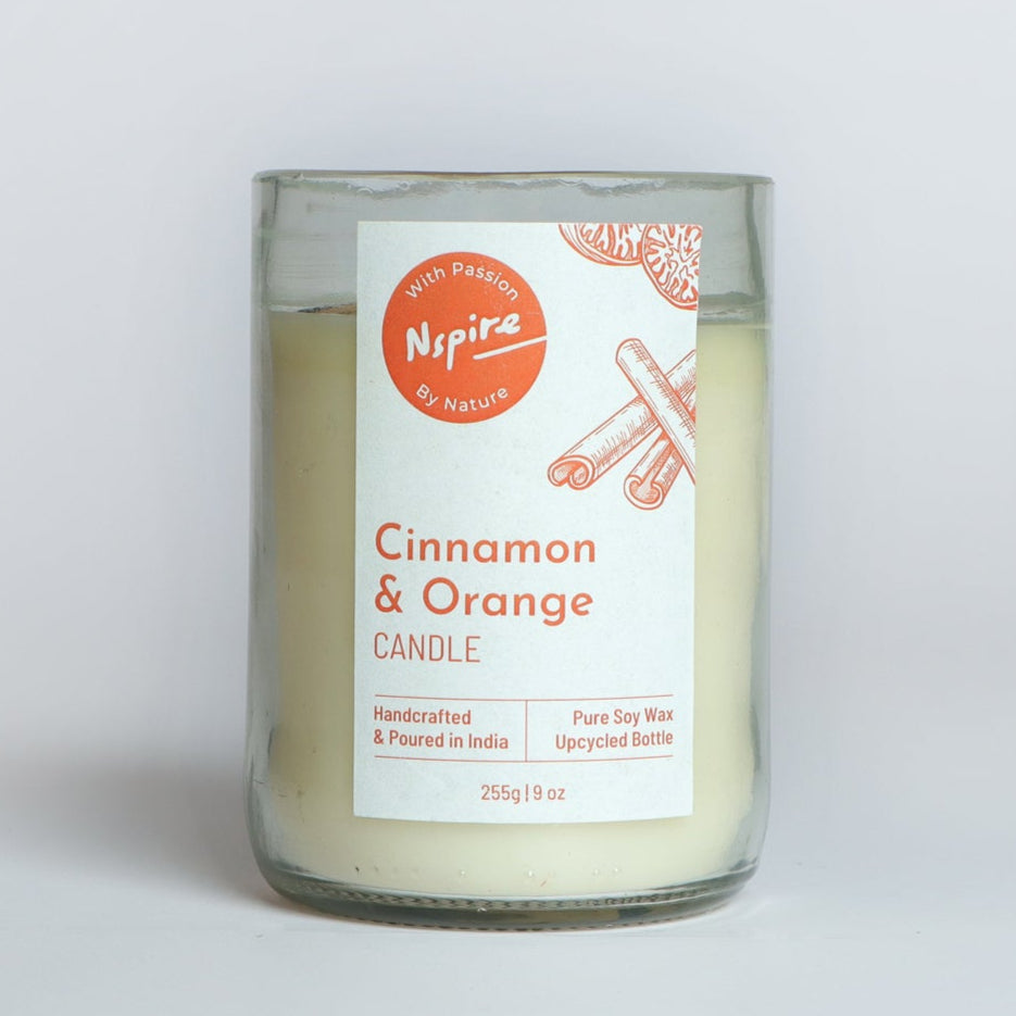 Soy wax candle with a warm cinnamon and orange scent, housed in an eco-friendly upcycled glass.