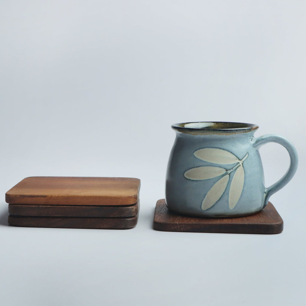 Set of four handcrafted wooden coasters in a square design, made from solid wood. Perfect for protecting surfaces from cups, glasses, and candles. A rustic and elegant addition to any home décor or as a thoughtful gift for special occasions
