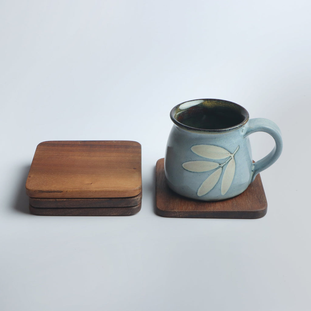 Set of four handcrafted wooden coasters in a square design, made from solid wood. Perfect for protecting surfaces from cups, glasses, and candles. A rustic and elegant addition to any home décor or as a thoughtful gift for special occasions
