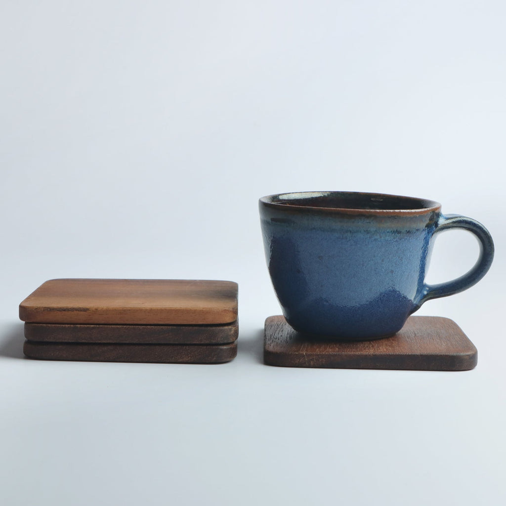 Set of four handcrafted wooden coasters in a square design, made from solid wood. Perfect for protecting surfaces from cups, glasses, and candles. A rustic and elegant addition to any home décor or as a thoughtful gift for special occasions
