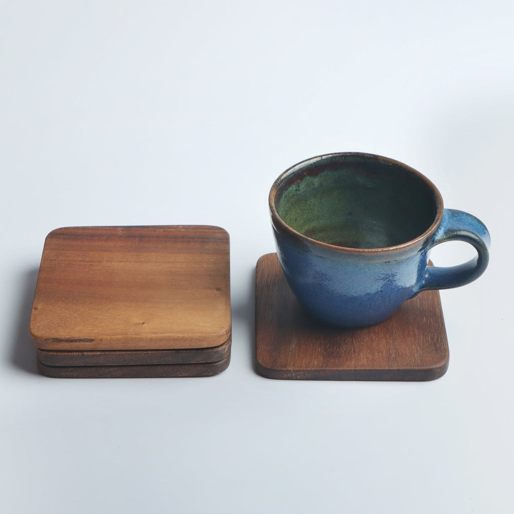 Set of four handcrafted wooden coasters in a square design, made from solid wood. Perfect for protecting surfaces from cups, glasses, and candles. A rustic and elegant addition to any home décor or as a thoughtful gift for special occasions
