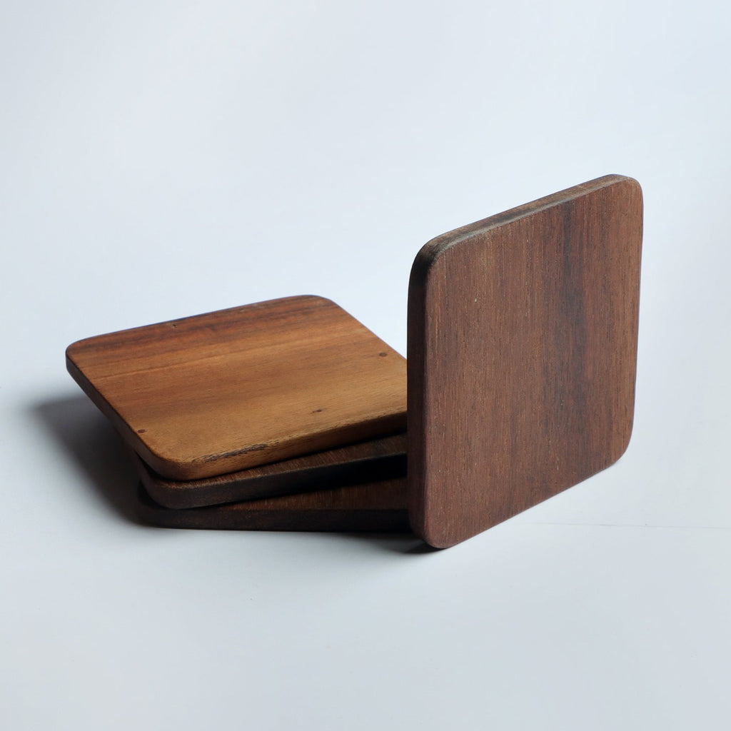 Set of four handcrafted wooden coasters in a square design, made from solid wood. Perfect for protecting surfaces from cups, glasses, and candles. A rustic and elegant addition to any home décor or as a thoughtful gift for special occasions
