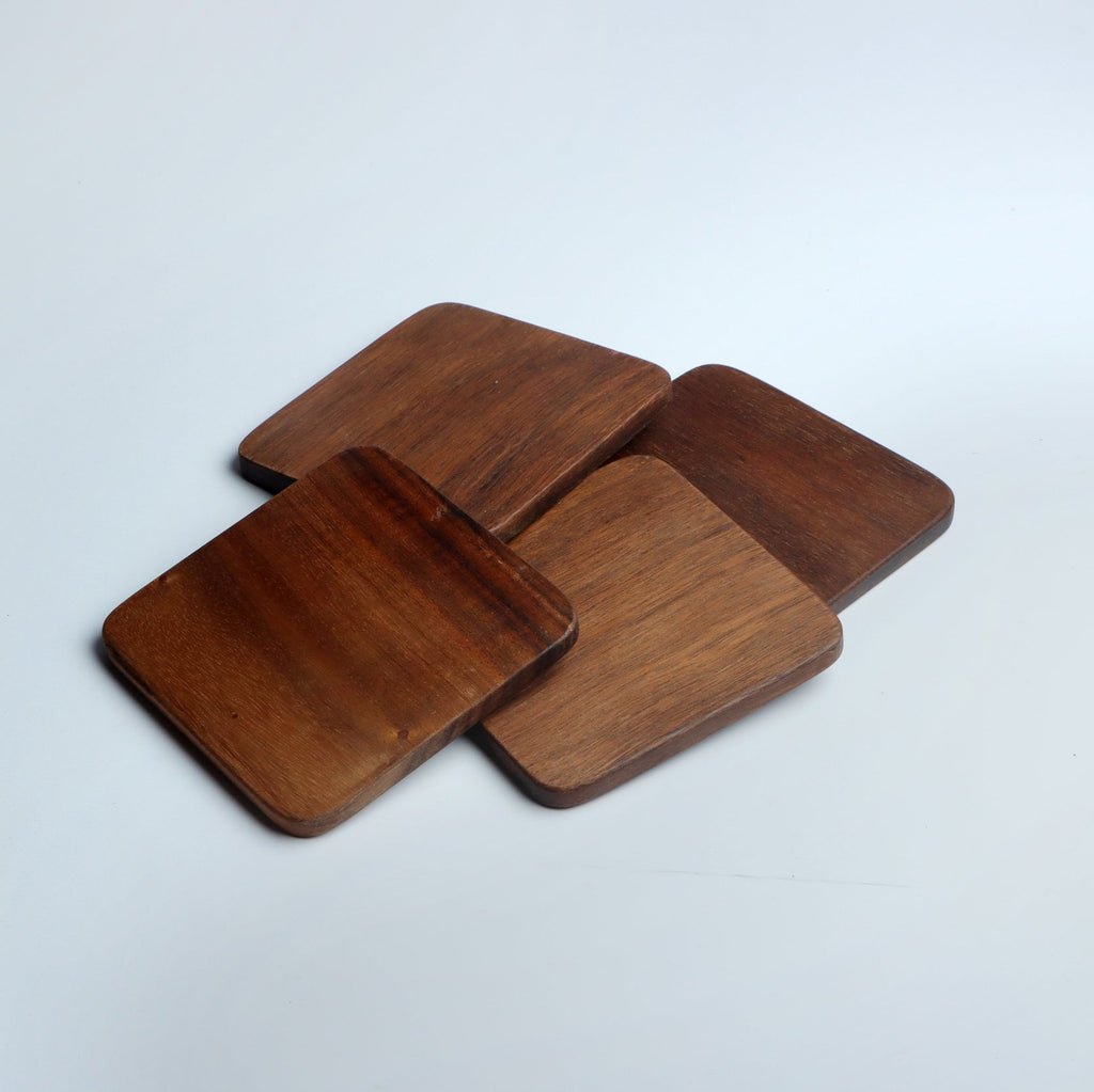 Set of four handcrafted wooden coasters in a square design, made from solid wood. Perfect for protecting surfaces from cups, glasses, and candles. A rustic and elegant addition to any home décor or as a thoughtful gift for special occasions
