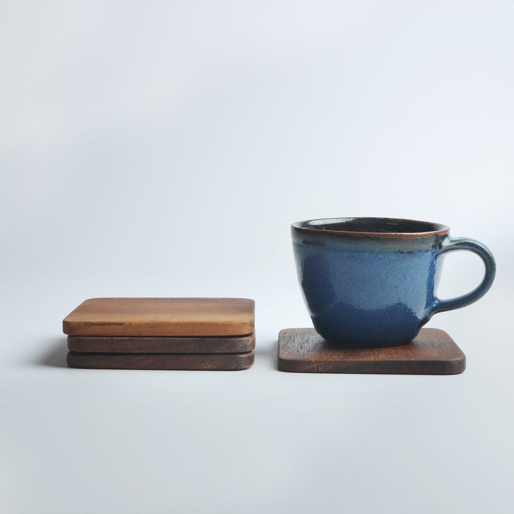 Set of four handcrafted wooden coasters in a square design, made from solid wood. Perfect for protecting surfaces from cups, glasses, and candles. A rustic and elegant addition to any home décor or as a thoughtful gift for special occasions
