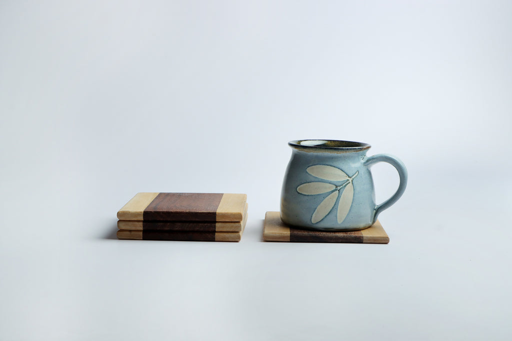 Set of four handcrafted wooden coasters in a square design, made from solid wood. Perfect for protecting surfaces from cups, glasses, and candles. A rustic and elegant addition to any home décor or as a thoughtful gift for special occasions
